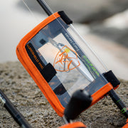 LureShield Pro XL strapped to a rod blank on the rocks, covering a rigged hard-body lure